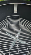 A Spider Huntsman grill with its lid open, showing a 17 inch Kick ash Basket inside. The basket handle is 2 inches below the secondary grate ledge
