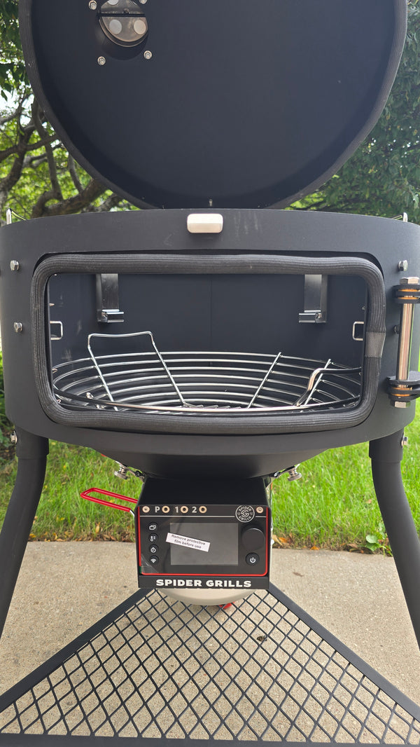 A side view of a Spider Huntsman grill with its lid open, showing a Kick Ash Basket inside.  The basket is KAB-BKT-C1912