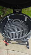 A Spider Huntsman grill with its lid open, showing a top view of a Kick Ash Basket, KAB-BKT-C1917