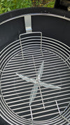 A Spider Huntsman grill with its lid open, showing a top view of a Kick Ash Basket, KAB-BKT-C1917