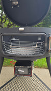 A Spider Huntsman grill with its lid open, showing a side view of a Kick Ash Basket, KAB-BKT-C1917