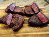 Seared steaks on cutting board